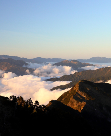 Sea of clouds over hills at sunrise
