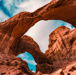 Red rock arch against a blue sky